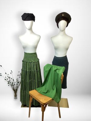 two mannequins are standing next to each other on a chair