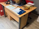 a desk with a computer on top of it in a room