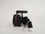 a close up of a fishing reel on a white surface