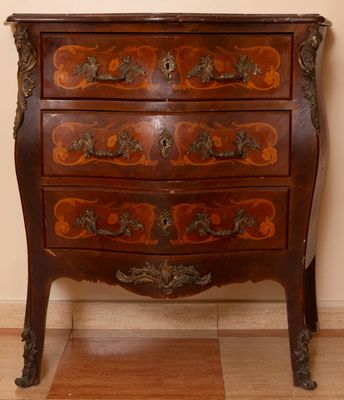 a small chest of drawers with a clock on top of it