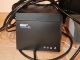 a small black box with wires connected to it on the floor