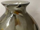 a glass vase that is sitting on a table
