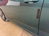 a close up of a car door with a sticker on it