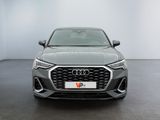 the front of a grey audi vehicle in a white room