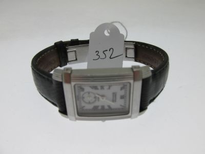 a watch with a price tag attached to it ' s wrist