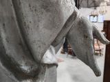 statue of a woman holding a baby in her arms in a shop