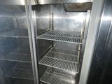 an empty refrigerator in the corner of a room