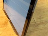 a laptop computer sitting on top of a wooden table