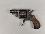 an old gun with a wooden handle on a white surface