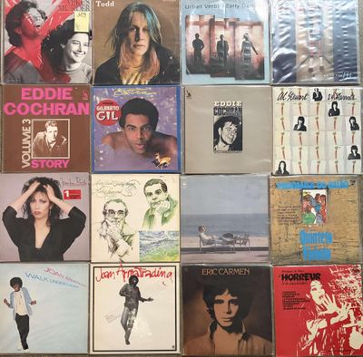 many different album covers on the wall of a room