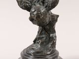 an image of a bronze statue of a bird on a pedestal