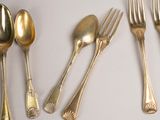five forks, two spoons, and two spoons on the table