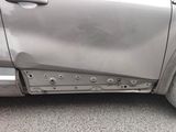 a close up of a car door with holes in it