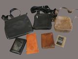 many different types of purses and wallets laid out on a table