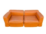 pair of orange leather sofas on white background