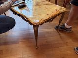 a man sitting at a table with a laptop on it