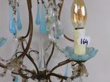 a chandelier with a candle and a number on it
