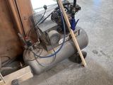 a small air compressor sitting in a garage