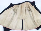an old jacket with a red and black stripe on it