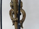 pair of black and gold candlesticks on a black marble base