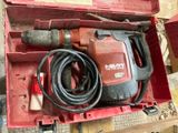 a red box with a drill and a cord in it