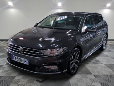 the black volkswagen passat is parked in a large room