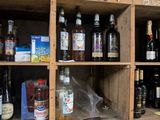 many bottles and glasses on the shelves in the room