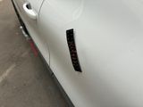 a close up of a car door with a sticker on it