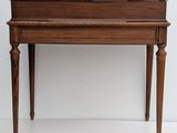a small wooden table with a drawer on it