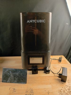 a small machine that is sitting on a wooden table