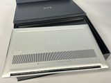 two laptops sitting on top of each other on a table