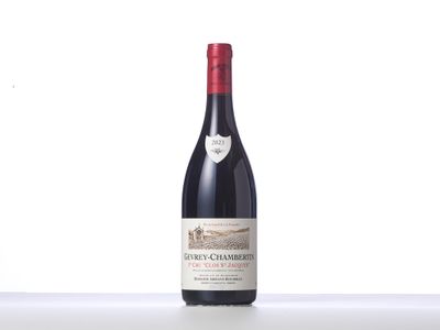 a bottle of red wine sitting on top of a table