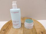 a bottle of lotion and a container of lotion sitting on a wooden tray