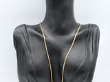 a black mannequin with a gold chain on it