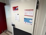a white refrigerator in a room with a red door