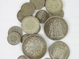 a pile of old coins on a white surface