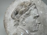 an image of a bust of a man with a hat on