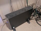 a television sitting on the floor next to a bunch of wires