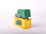 a green toy truck sitting on top of a yellow box