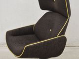 an image of a brown chair with yellow piping on it