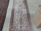 two rugs sitting on the floor next to a box