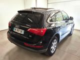 the rear end of a black audi qx parked in a garage