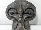 une vieille poignée de porte en métal ornée d'un motif décoratif