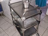a metal cart with a pot on top of it