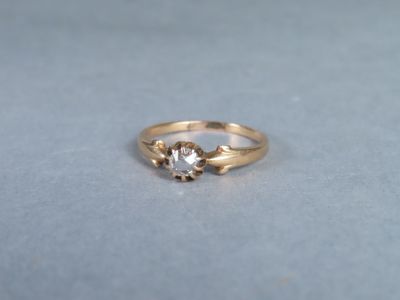 a close up of a gold ring with a diamond on it