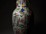 a vase with a picture of people on it in the dark