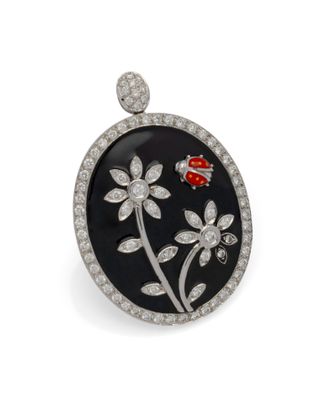 un gros plan sur une broche en noir et blanc ornée d'une coccinelle
