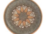 a plate with a star design on it on a white background