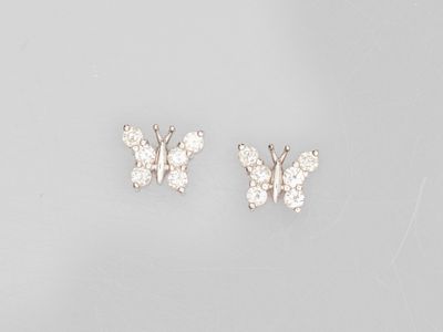 a pair of diamond butterfly earrings