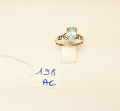 a close up of a ring with a blue stone on it